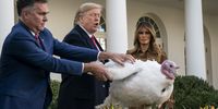 WASHINGTON, DC - NOVEMBER 26: U.S. President Donald Trump gives a presidential pardon to the National Thanksgiving Turkey Butter during the traditional event with first lady Melania Trump, National Turkey Federation Chairman Kerry Doughty and others in the Rose Garden of the White House November 26, 2019 in Washington, DC. The turkey pardon was made official in 1989 under former President George H.W. Bush, who was continuing an informal tradition started by President Harry Truman in 1947. Following the presidential pardon, the 47-pound turkey which was raised by farmer Wellie Jackson of Clinton, North Carolina, will reside at his new home, 'Gobbler's Rest,' at Virginia Tech. (Photo by Drew Angerer/Getty Images)