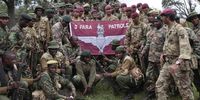 Soldiers from the British Army's 3rd Battalion, Parachute Regiment, pose with Kenyan wildlife rangers for photographs in a forest near Nanyuki, 200km north of the capital Nairobi, Kenya, 5 December 2013. (Photo: Dai Kurokawa / EPA)