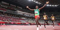 TOKYO, JAPAN - JULY 30: Gold medalist Selemon Barega of Team Ethiopia celebrates as he crosses the finish line ahead of silver medalist Joshua Cheptegei of Team Uganda and bronze medalist Jacob Kiplimo of Team Uganda in the Men's 10,000 metres Final on day seven of the Tokyo 2020 Olympic Games at Olympic Stadium on July 30, 2021 in Tokyo, Japan. (Photo by Patrick Smith/Getty Images)