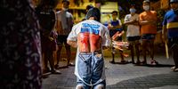 A flagellant whips his bloodied back as penance outside a closed church, defying government orders to avoid religious gatherings and stay home to curb the spread of the coronavirus, as they commemorate Good Friday on April 2, 2021 in Manila, Philippines. The Philippines, the only predominant Catholic country in Asia, observe the days that led to the crucifixion of Jesus Christ as one of the most important religious days of the year. As with last year, the onset of the coronavirus pandemic and with the world's strictest and longest lockdown halted most religious events during this time. Parts of the Philippines remain under strict lockdown as cases hit daily records amid the spread of new and more contagious variants. (Photo by Ezra Acayan/Getty Images)