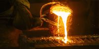 Gold is poured into a mould.