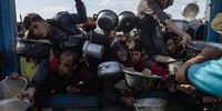Palestinians, including children, hold metal pots and pans as they gather to receive food cooked by a charity kitchen, in Khan Yunis, southern Gaza Strip, 10 January 2025. According to the UN Palestinian refugee agency UNRWA, over 1.8 million people across the Gaza Strip are experiencing 'high levels' of acute food insecurity, with acute malnutrition ten times higher than before the war. According to the UN, at least 1.9 million people, about 90 percent of the population, across the Gaza Strip are internally displaced, including people who have been repeatedly displaced.  EPA-EFE/HAITHAM IMAD