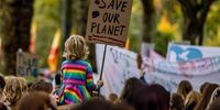 A young climate activist holding a placard reading "Save our planet" during a protest march on the "Youth Day" at the COP26 climate talks in Glasgow, U.K., on Friday, Nov. 5, 2021. Climate negotiators at the COP26 summit were banking on the worlds most powerful leaders to give them a boost before they embark on two weeks of fraught discussions over who should do what to slow the rise in global temperatures. Photographer: Jonne Roriz/Bloomberg via Getty Images