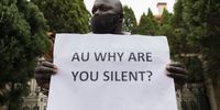 A man holds a poster asking why the African Union is silent? The Movement for Democratic Change Alliance (MDC) has plans to hold a massive demonstration when lockdown restrictions are over and will be holding night vigils at the embassy and consulates until their demands are met.<br>Photo / Shiraaz Mohamed.