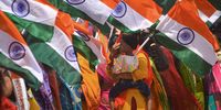 A supporter of the Bharatiya Janata Party (BJP) holds her child with a tricolour<br>flag during a boat rally to celebrate the 75th Independence Day of India, at Neelangarai beach, in Chennai, India, 10 August 2022.  (Photo: EPA-EFE / Idrees Mohammed)