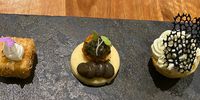 An onion and thyme marshmallow, smoked aubergine puree and minty pesto on an olive oil sablé, a kale trimmings muffin with fish mousse and a coral tuile. (Photo: Marthinus Ferreira)