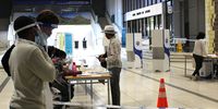 Elizabeth Coetzee, a resident of De Waterkant in the City of Cape Town, about to cast her ballot at the Cape Town Civic Centre polling station on Wednesday 9 December 2020. (Photo: Victoria O'Regan)
