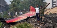 People stand near debris at the site of a plane crash near Sardar Vallabhbhai Patel International Airport in Ahmedabad, Gujarat, western India, 12 June 2025. Air India flight AI171, bound for London carrying 242 passengers and crew members on board a Boeing 787-8 aircraft, crashed minutes after take-off in the Meghaninagar area of Ahmedabad.  EPA-EFE/SIDDHARAJ SOLANKI