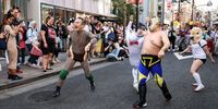 Wrestlers perform during Kagurazaka Bakeneko Festival on October 13, 2024 in Tokyo, Japan. The annual festival in Kagurazaka invites participants to embrace their feline side by dressing up as cats and showcasing their playful spirit. This unique Halloween-themed event offers a festive atmosphere with activities such as cat makeup, kimono rentals, making it a delightful experience for all ages. (Photo by Takashi Aoyama/Getty Images)