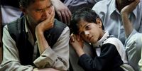 A man and a boy mourn the death of Abdul Rashid Chillo, a senior activist with the ruling National Conference party of Kashmir in Srinagar, in the state of Jammu and Kashmir, India. Chillo was gunned down by militants outside his home in Srinagar in 2002. (Photo by Paula Bronstein / Getty Images)