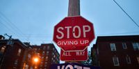 PHILADELPHIA, PA - OCTOBER 28:  A sticker attached to a stop sign reads "GIVING UP" with a poster affixed below encouraging everyone to vote, with the general election only six days away, on October 28, 2020 in Philadelphia, Pennsylvania.  With the election only a week away, this new form of in-person voting by using mail ballots, has enabled tens of millions of voters to cast their ballots before the general election. President Donald Trump held three rallies throughout Pennsylvania on Monday to bolster his reelection prospects.  (Photo by Mark Makela/Getty Images)