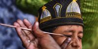 A Muslim boy has his eyes smeared with traditional Kohl eyeliner before attending prayers, at Walajah mosque, in Chennai, India, 22 April 2023. The beginning of Eid al-Fitr, which is determined by sighting of the new moon, was marked on 21 April in several countries while some countries are celebrating the three-day festival marking the end of Ramadan starting from 22 April.  EPA-EFE/IDREES MOHAMMED