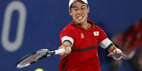 epa09376618 Kei Nishikori of Japan returns to Novac Djokovic of Serbia during the Men's Singles Quarterfinal Tennis match of the Tokyo 2020 Olympic Games at the Ariake Coliseum in Tokyo, Japan, 29 July 2021.  EPA-EFE/RUNGROJ YONGRIT