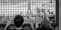 215 - Paris - 2022. "Two kids admiring the Tour Eiffel from behind an ugly fence." © Tommaso Carrara, Italy, entry, Open Competition, Street Photography, 2023 Sony World Photography Awards