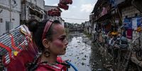 Chika Mochi, a transgender member of the Sanggar Seroja community, poses for photograph during a fashion show with theme 'Trans Super Heroes Carnival' as a form of concern for the impact of waste and climate change on minority groups at Duri traditional market on December 17, 2023 in Jakarta, Indonesia. The carnival featuring a fashion show of 15 models wearing costumes made from recycled plastic waste. The costumes were created by a collaboration between Sanggar Seroja and 7 transgender designers, each of whose costumes tells a story about the disparities in life experienced by transgender in Indonesia. (Photo by Ulet Ifansasti/Getty Images)