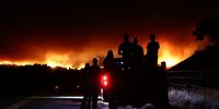 LOS OLIVOS, CALIFORNIA - JULY 06: People watch as the Lake Fire burns in Los Padres National Forest with evacuation warnings in the area on July 6, 2024 near Los Olivos, California. The wildfire has scorched 4,600 acres amid a long-duration heat wave which is impacting much of California. (Photo by Mario Tama/Getty Images)