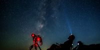 A member of the Astronomical Society watches the night sky to photograph a meteor during the Perseid meteor shower over the Kozjak Lake, 45km from the capital Skopje, North Macedonia, 12 August 2024.  EPA-EFE/GEORGI LICOVSKI