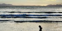 Dancing girl. It was taken at the beach in the Strand soon after sunset. She is unaware of me, and unknown to me. 