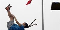 A girl jumps off a platform during a free jumping-diving competition at the Adrenaline Park, in Tehran, Iran, 31 May 2023. Some thirty youths participates in the competition before the rest was postponed due to bad weather.  EPA-EFE/ABEDIN TAHERKENAREH