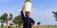 Linda Mushekwi, 15, balances a 20-litre bucket of water on November 22, 2020, near Luveve in Bulawayo, Zimbabwe. Linda bemoans the water crisis's negative impact on her school studies as she spends half of her day searching for water for a household of five people. (Photo: Zinyange Auntony)