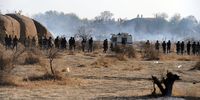Police after they opened fire on mine workers. (Photo: Felix Dlangamandla)