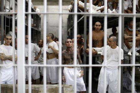 In El Salvador, shackled prisoners watch their mass trial on a big screen
