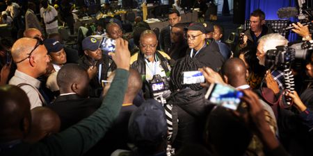 On the ground: Anxious rivals jostle together – all eyes on the results board