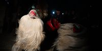 Costumed people, so-called 'Kukeri' mask dancers, perform a traditional dance during carnival celebrations in the village of Drugan, Bulgaria, 13 January 2022. The tradition of the Kukeri (singular: kuker) dancers performing to ward off evil spirits goes back to ritual games in ancient Thracians times held in honor of god Dionysus - known as a god of wine and ecstasy.  EPA-EFE/VASSIL DONEV