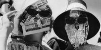 31st December 1963:  Two girls protect themselves from the fierce glare of the sun with newspapers, during the Davis Cup Challenge Tennis Championships, in Adelaide.  (Photo by Keystone/Getty Images)