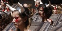 Animal Rights activists from the PeTA and AnimaNaturalis groups wear bullhorns, mock blood stains and pillories as they protest against bullfighting at the City Hall Square in Pamplona, northern Spain, 05 July 2024, on the eve of the annual Sanfermines festival that runs from 06 to 14 July 2024.  EPA-EFE/Jesus Diges