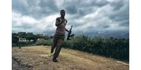 An Inkatha Freedom Party supporter runs back from the dividing line between political factions after emptying his AK-47 ammunition clip towards the homes of African National Congress supporters in Umlazi Township. Eight thousand IFP fighters received training in the Caprivi Strip from elements of the South African police and military. There are still arms caches buried across KwaZulu-Natal that have not yet been unearthed despite a massive one discovered and destroyed in 1999. Photo Greg Marinovich