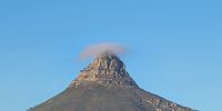Clear blue sky but this little cap on Lions Head is a sure indicator that rain is imminent. Photographer: Pete Grobler
