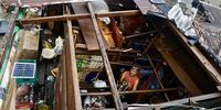 An elderly villager woman collects belongings inside a damaged home in the typhoon-hit municipality of Baler, Aurora province, Philippines, 18 November 2024. Local government units in  typhoon Man-yi’s path from Bicol region to Luzon region conducted pre-emptive evacuation of citizens to safeguard against floods and strong winds.  EPA-EFE/FRANCIS R. MALASIG