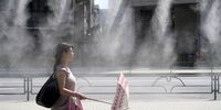 Holding an umbrella, a woman walks past a mist spray on a hot day in Tokyo, Japan, 11 July 2023. According to preliminary data by the World Meteorological Organization, the first week of July was the hottest week on record.  EPA-EFE/FRANCK ROBICHON