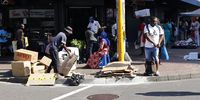 A garbage collector prepares a load of cardboards to be sold to recyclers in the City. (Photo: Felix Dlangamandla)