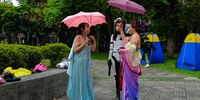 epa09925751 Star Wars fans use umbrellas to shelter from rain at the street during the Star Wars day celebration in Taipei, Taiwan, 04 May 2022. Star Wars Day is celebrated every 04 May by many fans in different parts of the world.  EPA-EFE/RITCHIE B. TONGO