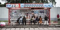 Presidential election posters stands above people waiting at a bus stop in Kinshasa, Democratic Republic of the Congo, on 11 January 2019. (Photo: John Wessels / Bloomberg via Getty Images)