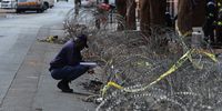 A police officer reading notes at the scene of the building that burnt down leaving 74 people dead on the corner Alberts and Delvers streets in Johannesburg on 01 September 2023. (Photo: Felix Dlangamandla)