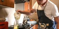 Dries Human demonstrating how only water is added to the dry pancake mix, ready for <br>baking.<br>(Photo: Christiaan Kotze)