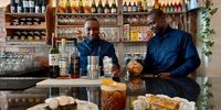Bartender Mandla Gumede and Pascal Masters serve a gin-based summer espresso with the mfino and poached egg on dombolo toast breakfast, left, and right the specialty burger with a venison patty and cheddar between flatbread. (Photo: Wanda Hennig)<br>