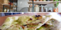 Jars upon jars of pickled and fermented foods, above, and wood-fired puffy flatbread, right. (Photos: Georgina Crouth)<br>