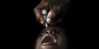 A child receives a drop of oral polio vaccine in the south-eastern village of Kakoukro, in Adiaké District. A three-and-a-half-year-old girl, Aicha Traoré, tested positive for polio in this village in December 2008, the first documented polio case in the country in four years. 2009, Mali. (Photo: © UNICEF)