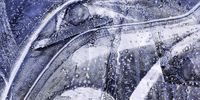 Abstract Beauty. Forced to refrain from travel, I turned to landscape photography closer to home, and became obsessed by the colours, patterns and textures that appear in frozen puddles. To me, these puddles are a source of wonder, even in an otherwise uninspiring location. Sometimes, ice is transparent and crisp; at other times, its multiple layers of freezing and thawing ice become opaque and cloudy. My intent was to capture the landscape in ice form, photographing its transient and fragile beauty. © Carol Graham, United Kingdom, Shortlist, Professional, Landscape, 2021 Sony World Photography Awards