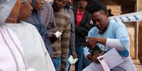 The presiding officer at M.C. Weiller L.P. School in Alexandra scanned ID documents as voters waited in line on election day. Photo: Greg Nicolson
