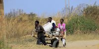 A man pulls a cart with a client’s belongings for a fee in an impoverished settlement in Hopley, Harare, on 23 June 2021. Due to the Covid-19 induced lockdown, many Zimbabweans are struggling to make ends meet. Almost half of the people in the country earn their living by informal trading. Children are the worst hit, according to a World Bank social and economic update report. (Photo: EPA-EFE / Aaron Ufumeli)