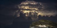 "Ballos Storm Behind the Cliff". Violent midnight storms over the Aegean Sea, captured from a cliff above Chora on Folegandros island, in October 2021. I was admiring the amazing powers of nature. © Anargyros Dekavallas, Greece, Shortlist, Open, Landscape, 2022 Sony World Photography Awards
