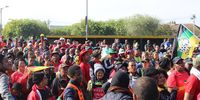 Cosatu members gather outside the Athlone Police station on Workers Day to hand over a memorandum to the Athlone SAPS, demanding better policing and an end to gang violence. (Photo: Sandisiwe Shoba)