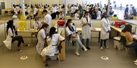 Nurses wait to  administer the corona vaccine to medical workers in Sao Paulo, Brazil. (Photo by Miguel Schincariol/Getty Images)
