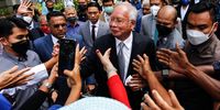 Malaysia's former prime minister Najib Razak (C) speaks to his supporters during a break in his final appeal trial outside the Federal Court in Putrajaya, Malaysia, 23 August 2022. The Malaysia highest court has scheduled hearings through 26 August 2022 to hear Najib's appeal of his convictions for criminal breach of trust, abuse of power and money laundering over the alleged theft of 4.4 billion Euro from 1Malaysia Development Berhad (1MDB), a state fund he co-founded as premier in 2009.  EPA-EFE/AHMAD LUQMAN ISMAIL