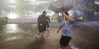 epa09442067 People navigate heavy rains and flooded walkways at the Billie Jean King National Tennis Center as the remnants of Hurricane Ida hit the area in Flushing Meadows, New York, USA, 01 September 2021.  EPA-EFE/JUSTIN LANE